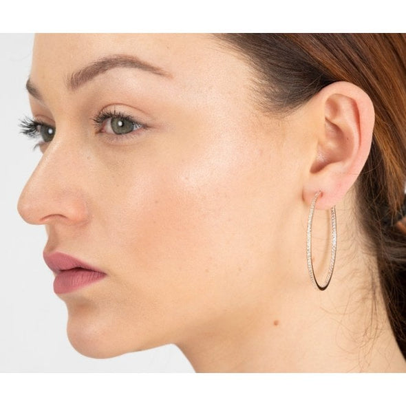 woman wearing cubic zirconia and rhodium plated silver large  hoop earrings with free gift pouch