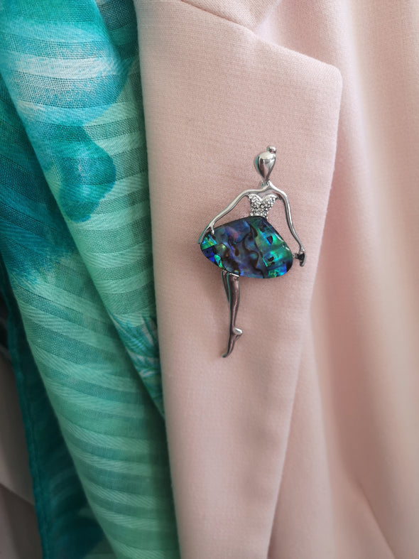 Abalone shell and crystal ballerina brooch worn on a pink jacket
