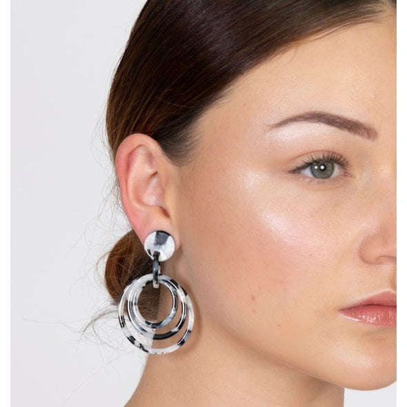 Black and white round triple hoop earrings on model