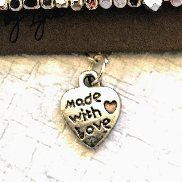 Close up of Made with love heart on bracelet