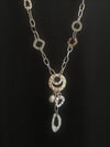 Long rose gold and silver necklace on a black background