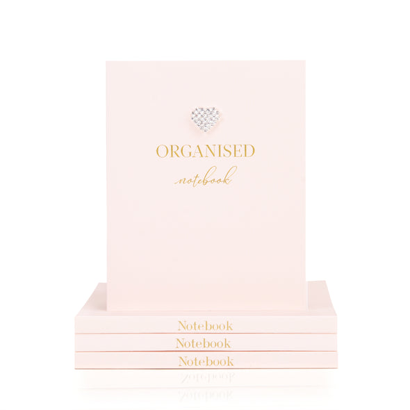 organised notebook with blank pages in pale pink with a raised dimante heart on front