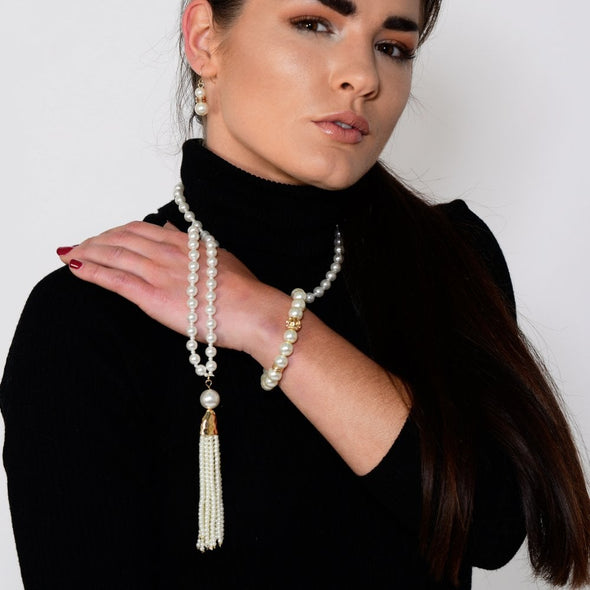 Long gold plated pearl tassel necklace on model