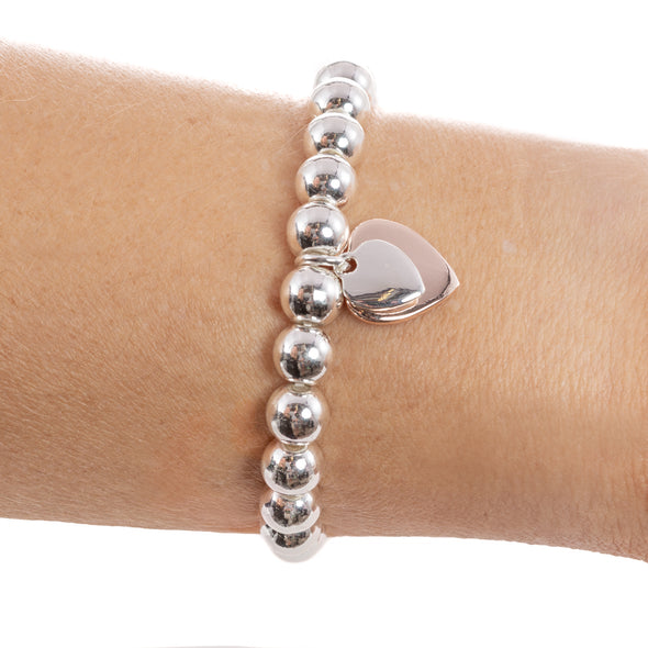 Silver Ball Bracelet with Double Rose Gold and Silver Heart Charm on writst